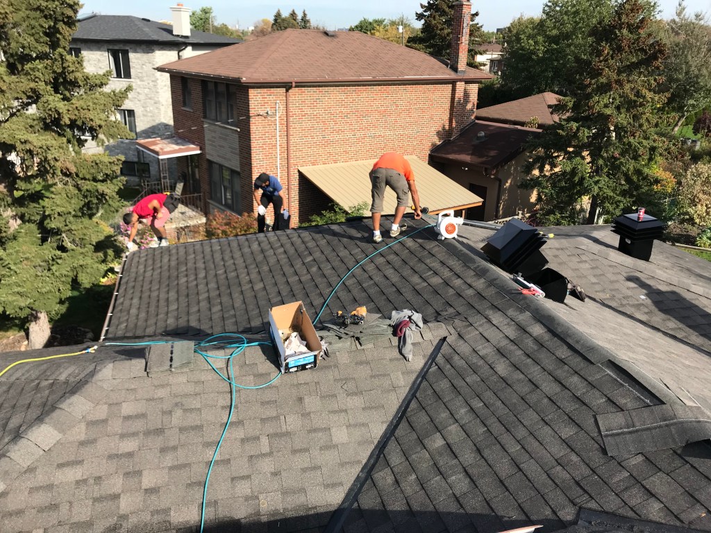 Toronto Roofing Specialists crew installing premium shingles on a GTA home
